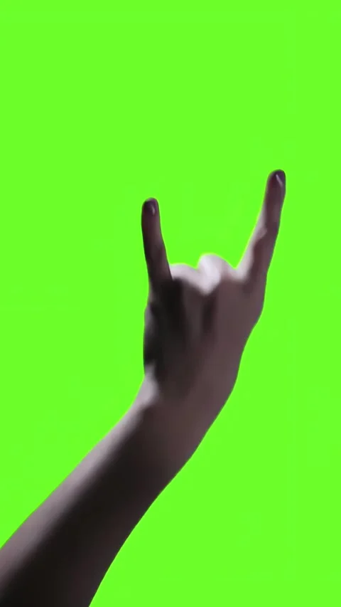 Woman with Rock and Roll Devil Horns Gesture Against Green Screen - 4K Vertical Stock Footage 285088102