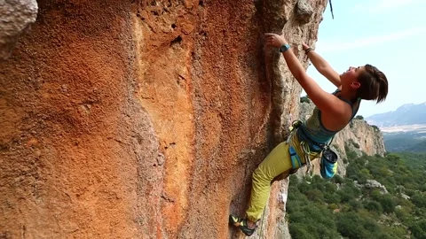 Woman rock climber climbing on the cliff Stock Footage