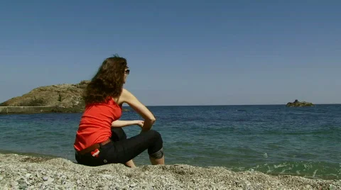 Woman on a rocky beach Stock Footage