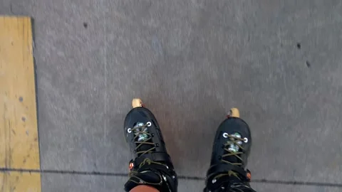 Woman rollerblading in top-down view along a paved path Stock Footage 345361724