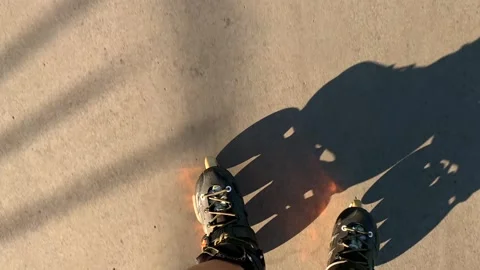Woman rollerblading in top-down view along a marked paved lane Stock Footage 345361784