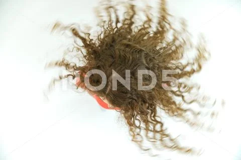 The woman rotate her head on the white background. View from above Stock Photos