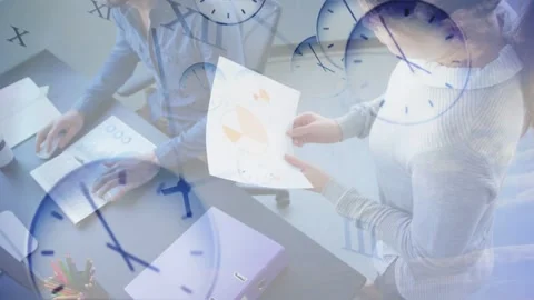 Woman rotating chart and pointing, urging seated man reviewing business charts, Stock Footage 335739610