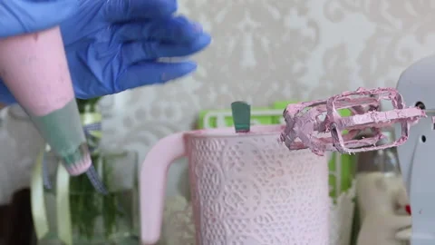 A woman in rubber gloves forms marshmallows from a pastry bag. On corollas th Stock Footage 134449879
