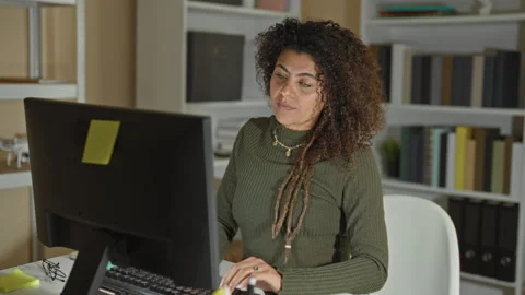 Woman rubs shoulder while using computer and mouse at desk in office buildi.. Stock Footage 339180256