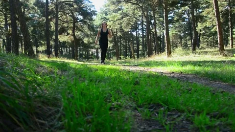 Woman runner jogging on forest path in park. Video stock 83919200