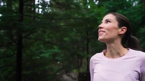 Woman runner jogging on forest path stops to enjoy nature. Stock Footage 95642967