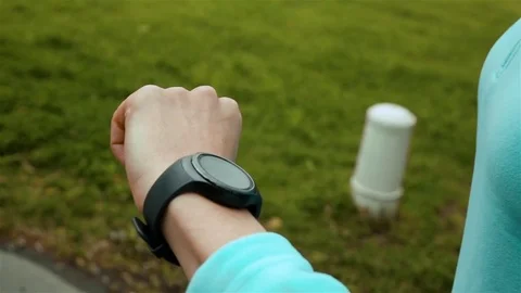 Woman runner using smart watch fitness tracker Stock Footage
