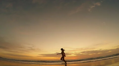 Woman running on beach Stock Footage