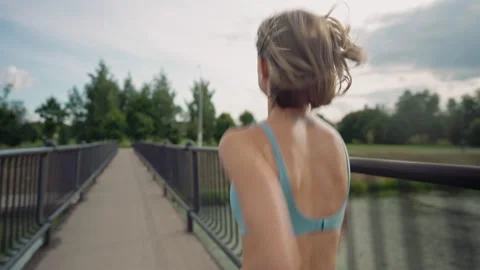 Woman running in the middle of the bridge. Background shot. Abstract concept of Video stock 159730045
