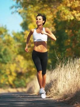 Woman is running outdoor, cardio and fitness in nature with physical activity Stock Photos