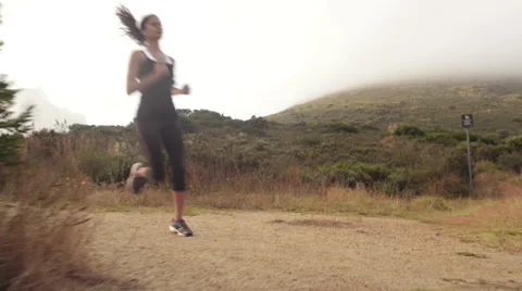 Woman running trail steadicam shot Stock Footage