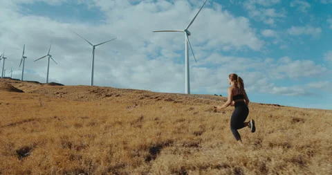 Woman Running with Windmills Stock Footage 194222453