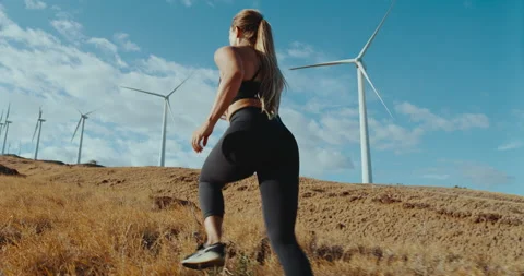 Woman Running with Windmills Stock Footage 194224088