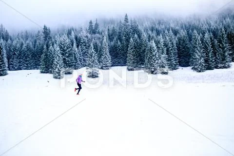 Woman running in winter, fitness inspiration and motivation Stock Photos