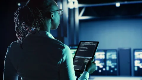 Woman runs code in data center Stock Footage 251594432