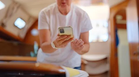 Woman Sailor Studying Navigation Map Inside Yacht Cabin Interior Stock Photos