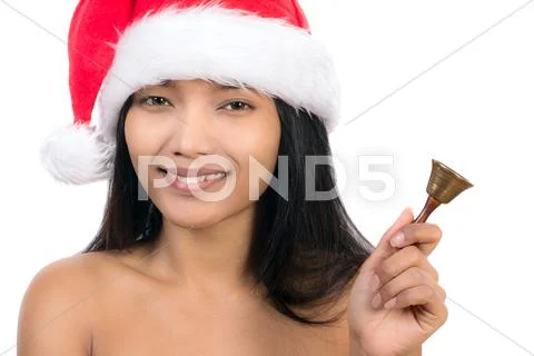 Woman with Santa Claus hat holding hand bell Stock Photos