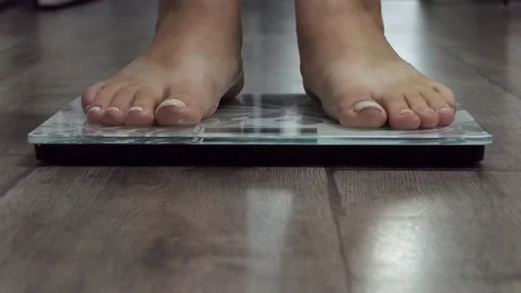 Woman On Scales Measure Weight. Girl Leg, Stock Video