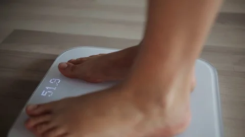 Woman On Scales Measure Weight. Girl Leg, Stock Video