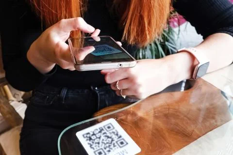 Woman scanning the barcode qr code in restaurant or cafe Stock Photos