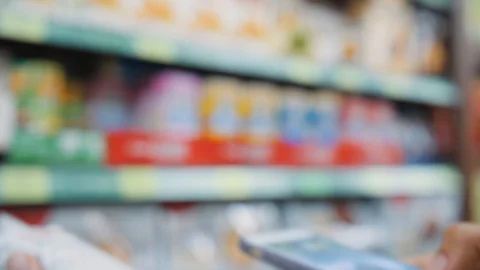 Woman Scanning Product Bar Code in the Shop Using Mobile Phone App. Digital Stock Footage 121496481