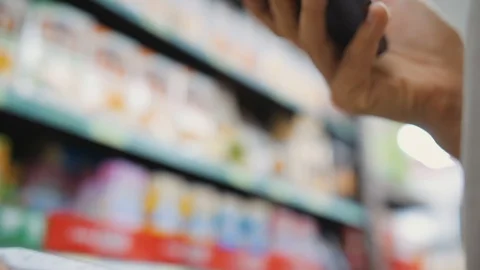 Woman Scanning Product Bar Code In The Supermarket Using Mobile Phone App Stock Footage 122400280