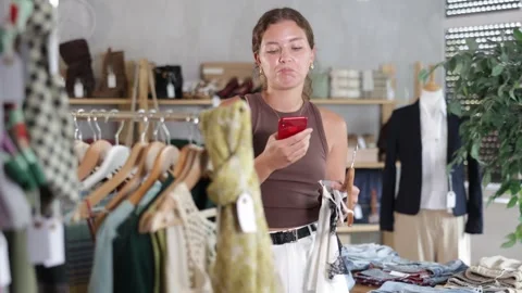 Woman scans the QR code of the topic on mobile phone with interest and reads the Video stock 330041743