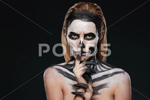 Woman with scared halloween makeup showing silence gesture Stock Photos