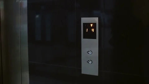 Woman with scarf press the button in the elevator. Female standing in office and Stock Footage 73145720