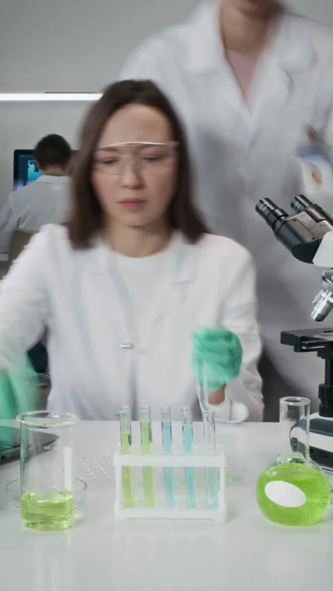Woman Scientist Doing Tests with Microscope in Laboratory Time Lapse Vertical Stock Footage 330677355