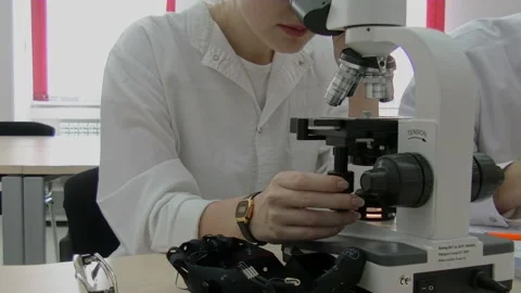 Woman scientist start working with microscope. Microbiologist looking microscope Stock Footage 85509213
