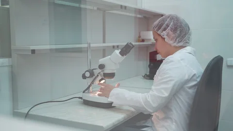 Woman scientist start working with microscope. Microbiologist looking microscope Stock Footage 127622497