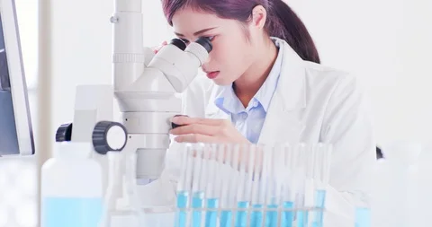 Woman scientist use microscope Stock Footage 96217633