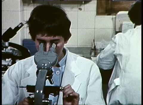 WOMAN SCIENTIST USING MICROSCOPE (1969) Stock Footage 158994814