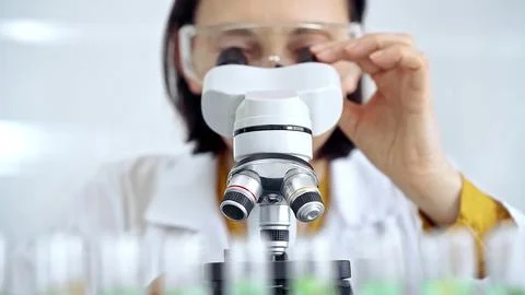 Woman scientist using microscope in laboratory. Microbiology science concept 스톡 사진