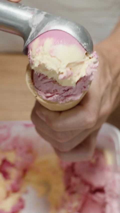 A scoop of pink ice cream in a specializ, Stock Video