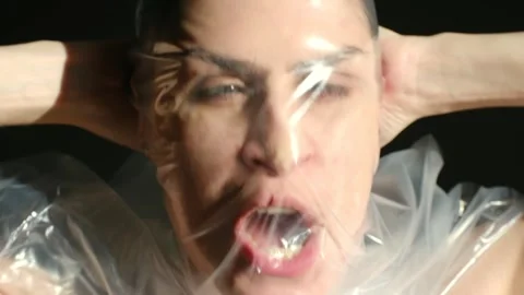 Woman screaming for help while trapped under plastic wrap Stock Footage 323896682