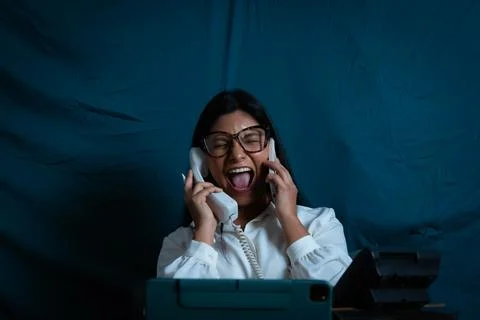 Woman screaming while managing multiple phones and stress Stock Photos