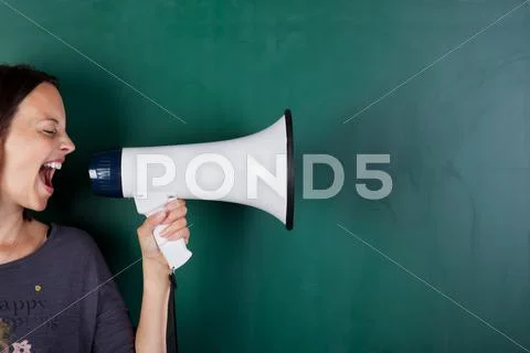 Woman screams into megaphone Stock Photos