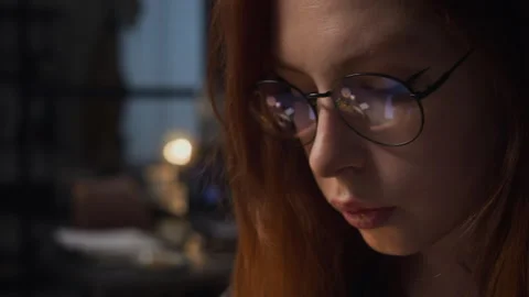 Woman with Screen Reflection in Glasses Working Late in Office Stock Footage 338412879