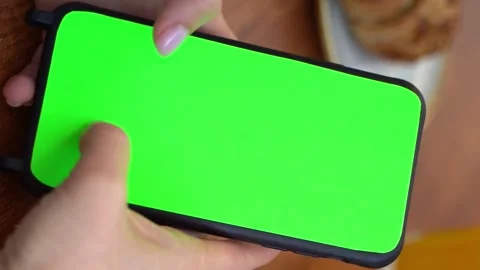 Woman scrolling internet using mobile cell phone with green chroma key screen Vídeo Stock 242347043