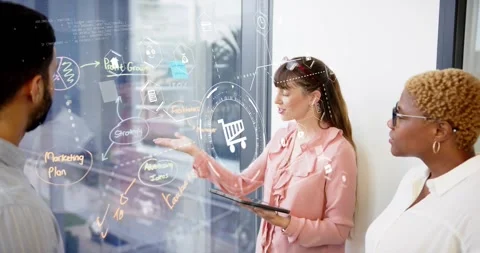 Woman scrolling tablet highlighting chart, man sketching marketing plan on glass Stock Footage 318918052