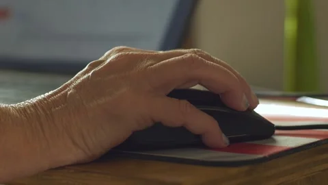 A woman scrolling through a web page using a mouse Stock Footage 337136025