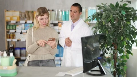 Woman scrolls through online catalog on the pharmacy website against the Stock Footage 318946321