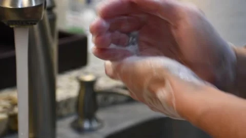 Woman Scrubbing and Washing her Hands with Soap to Prevent Illness and Pandemic Stock Footage
