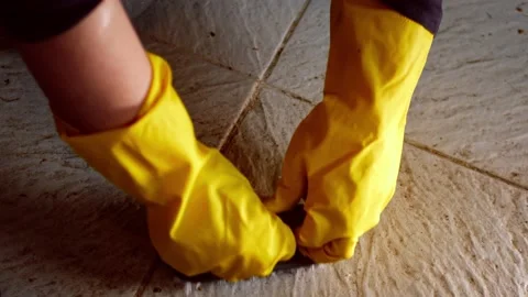 Woman scrubbing dirty floor with brush Stock Footage