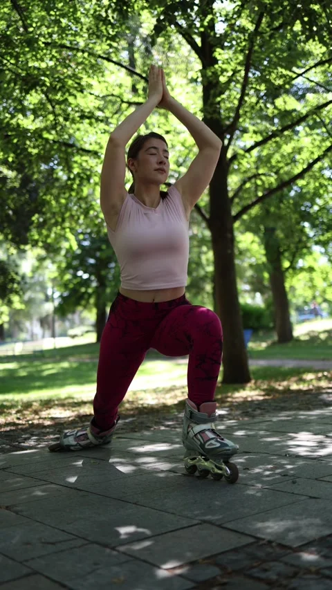Woman seeks inner peace while balancing in yoga pose on roller skates Видео 341476286