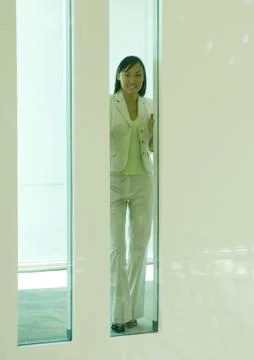 Woman seen through rectangular window Stock Photos