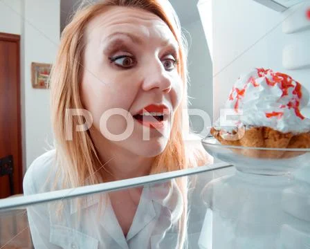 Woman Sees The Sweet Cake In The Fridge